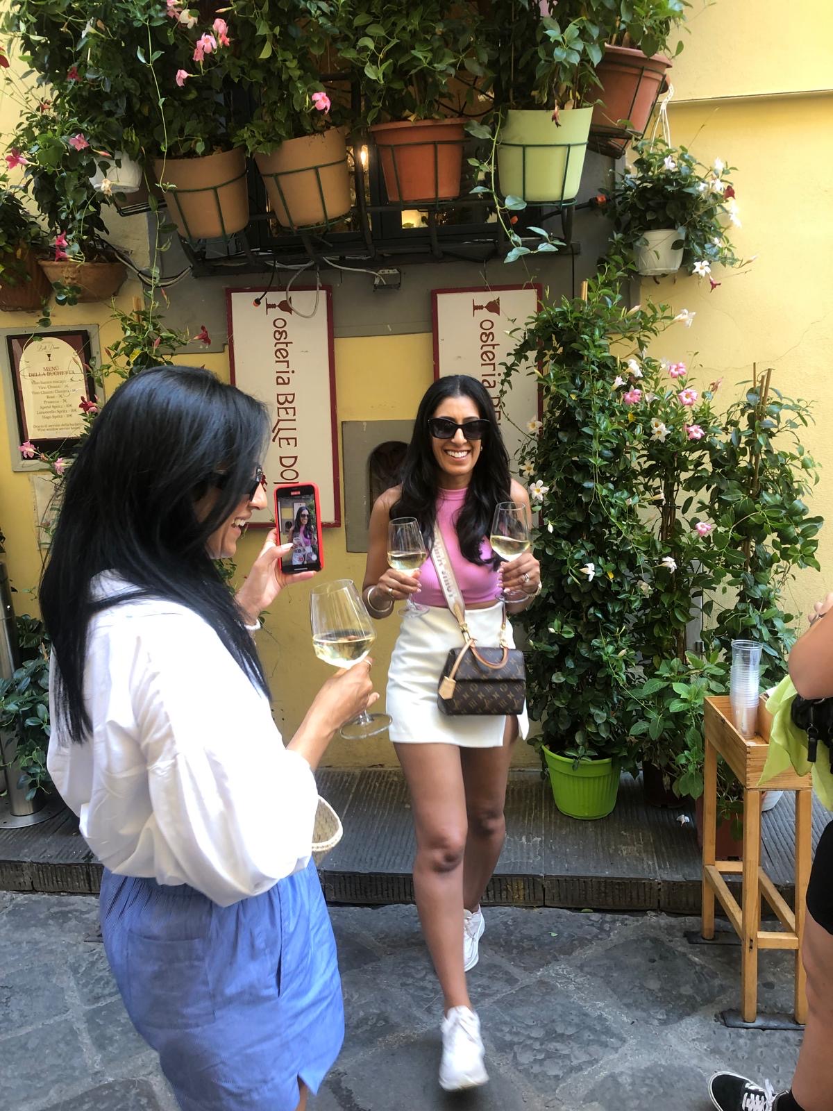Guests raising wine glasses at Osteria Belle Donne in Florence