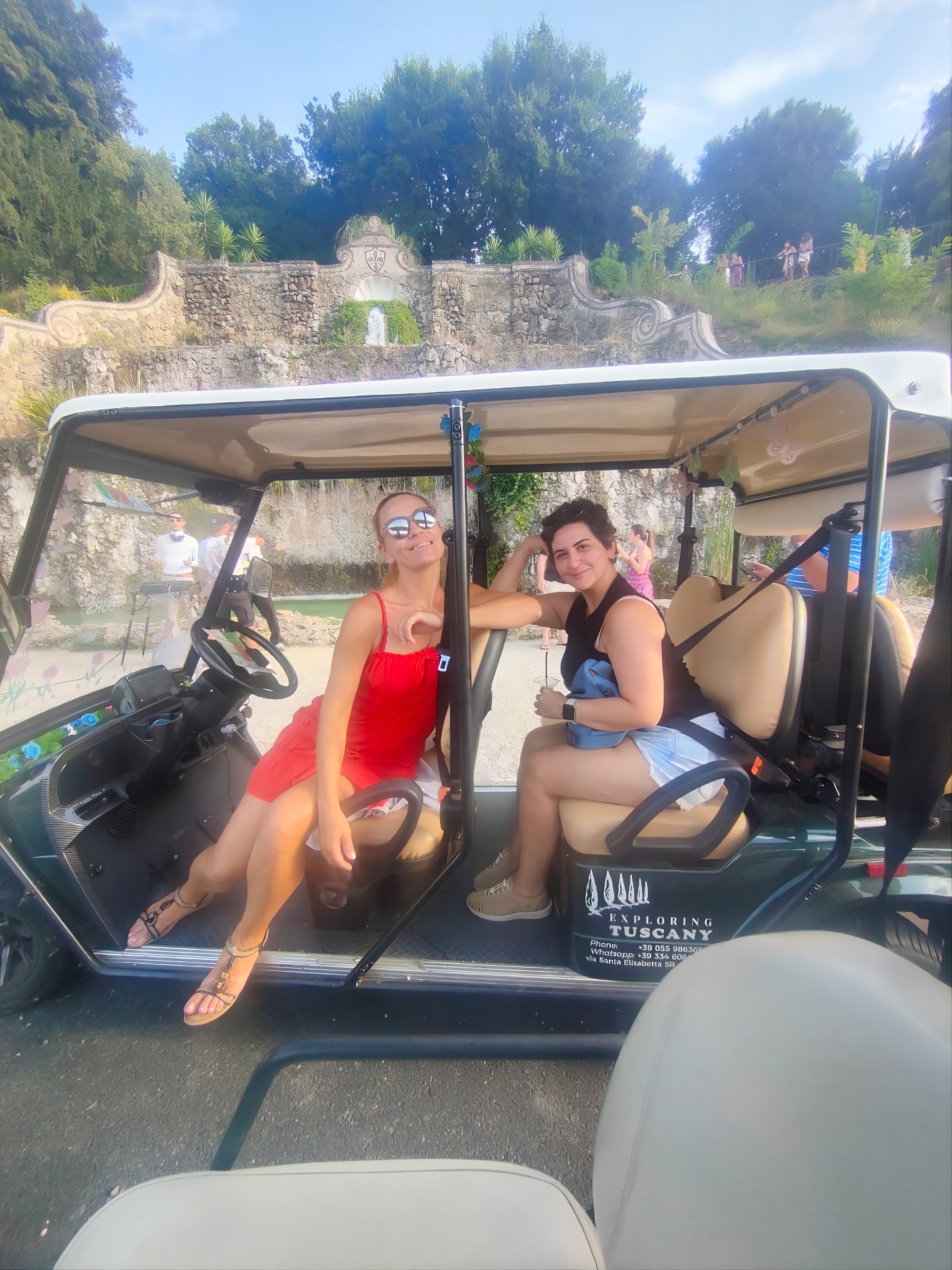 Two guests in the golf cart at a Florentine fountain
