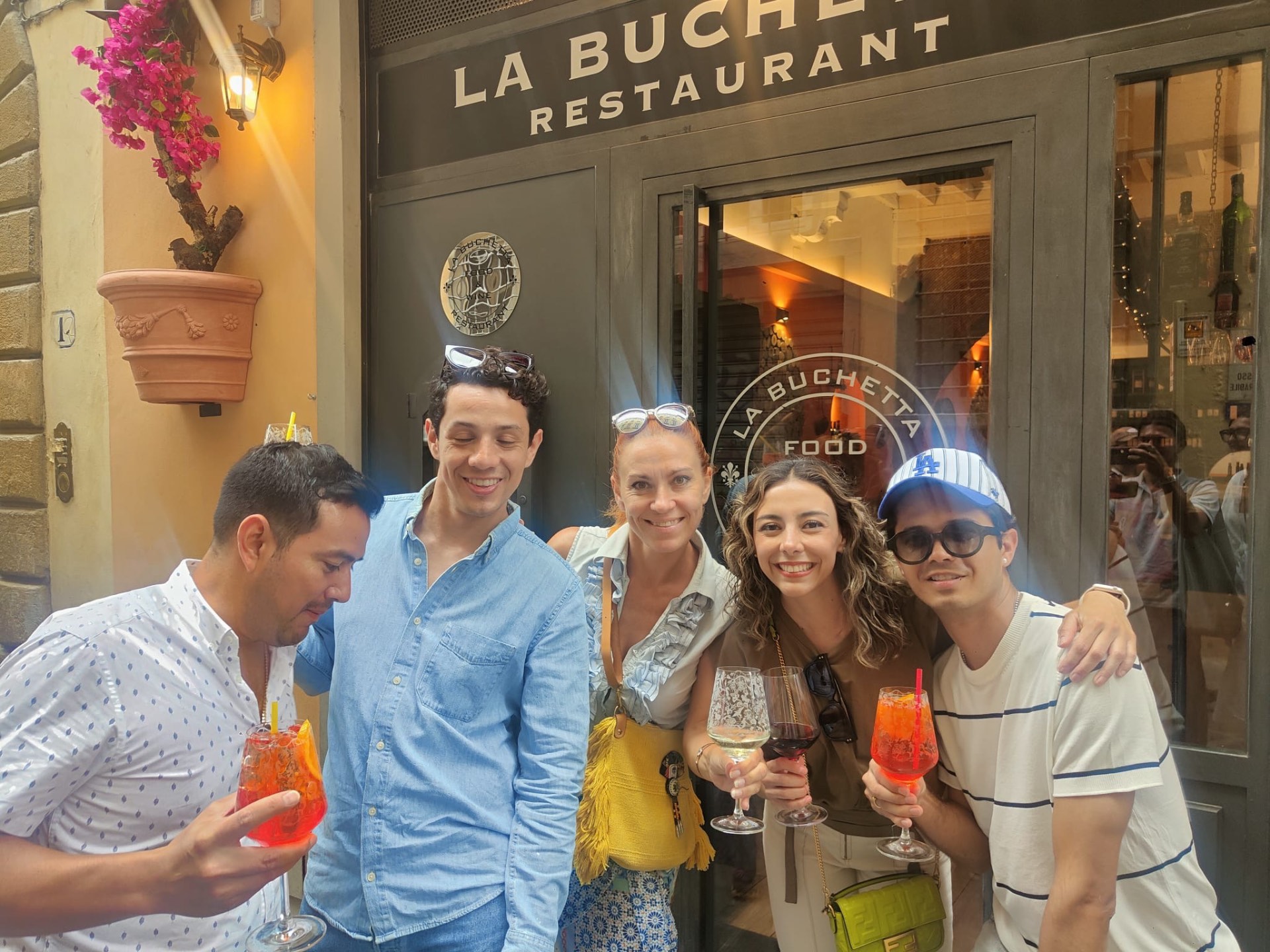 Guests toasting spritz outside La Buchetta Restaurant in Florence